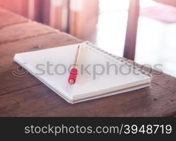 Work station with notebook and pencil with vintage filter, stock photo