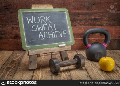 work, sweat, achieve - motivational writing with white chalk on a vintage slate blackboard with dumbbell and kettlebell, exercise and fitness concept