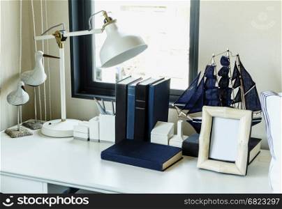 work table with lamp,pencil, books in a home