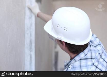 worker aligns wall for directing