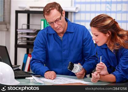 Worker and intern checking stock levels