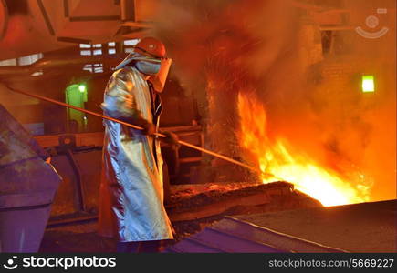 worker and production of cast iron inside of steel plant