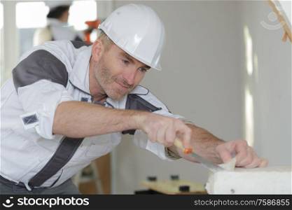 worker applying plaster with a spatula