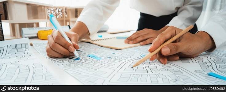Worker, architect and engineer work on real estate construction project oratory planning with cartography and cadastral map of urban town area to guide to construction developer business plan of city. Worker, architect and engineer work on real estate construction project oratory