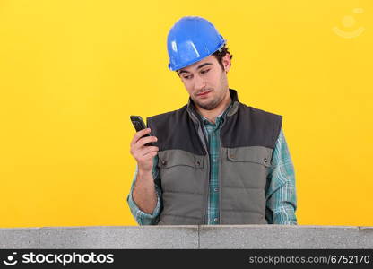 Worker behind wall