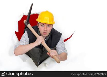 Worker bursting through with a pickaxe