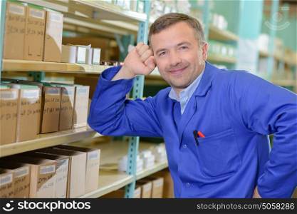 worker checking stock levels in store room