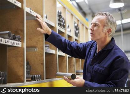 Worker Checking Stock Levels In Store Room