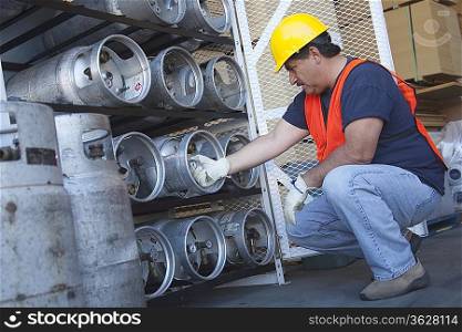 Worker checking the pressure of cylinder