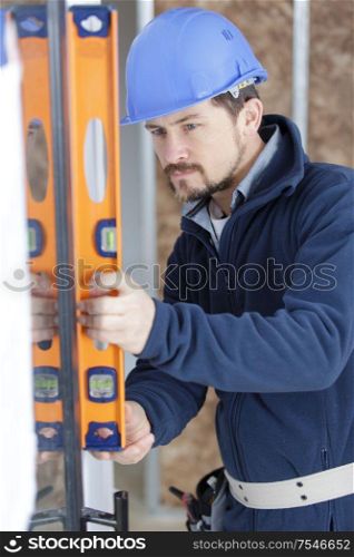 worker checks the level of a window