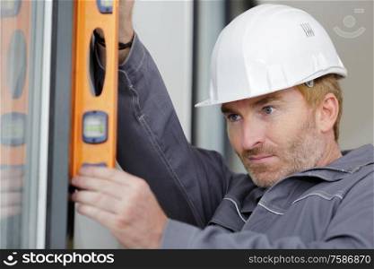 worker checks the level of a window