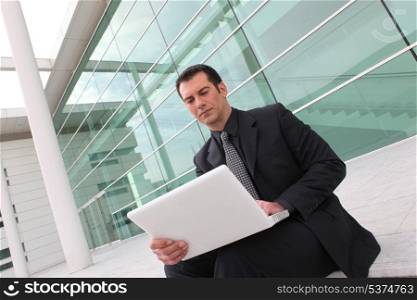 Worker connecting with laptop outdoors