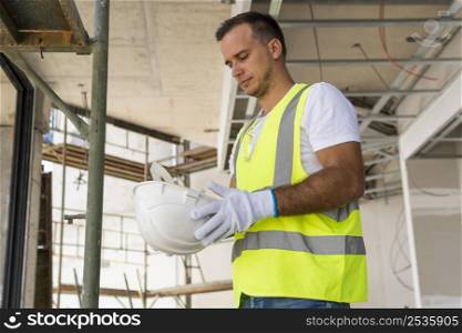 worker construction site holding helmet