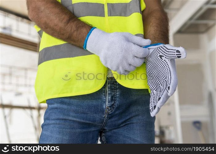 worker construction site putting gloves. Beautiful photo. worker construction site putting gloves