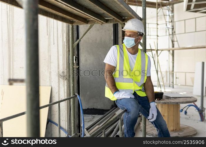 worker construction site wearing medical mask
