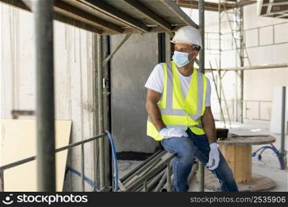 worker construction site wearing medical mask