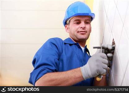 Worker cutting a wire