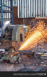 Worker Cutting of Steel in workshop