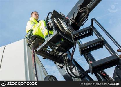 worker examines gates and cranes