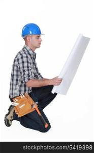 Worker examining building plans