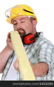 Worker eyeing a piece of wood