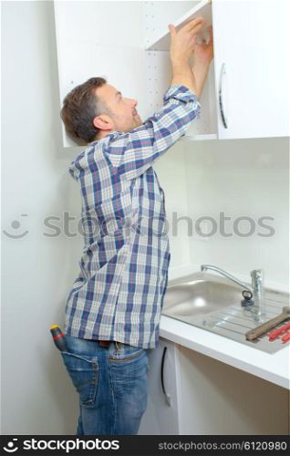 Worker fitting a kitchen