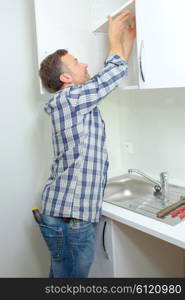 Worker fitting a kitchen