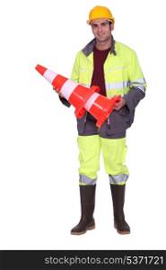 Worker holding a traffic cone