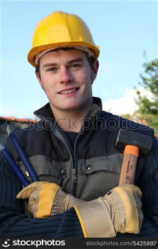 Worker holding hammer and chisel