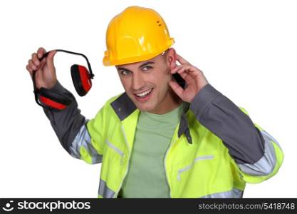 Worker holding hearing protection