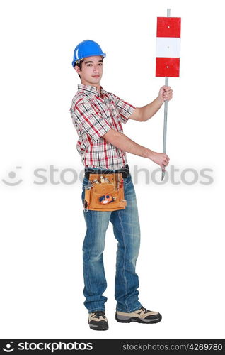Worker holding up road sign