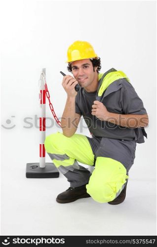 Worker in reflective work-wear using radio receiver