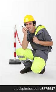 Worker in reflective work-wear using radio receiver