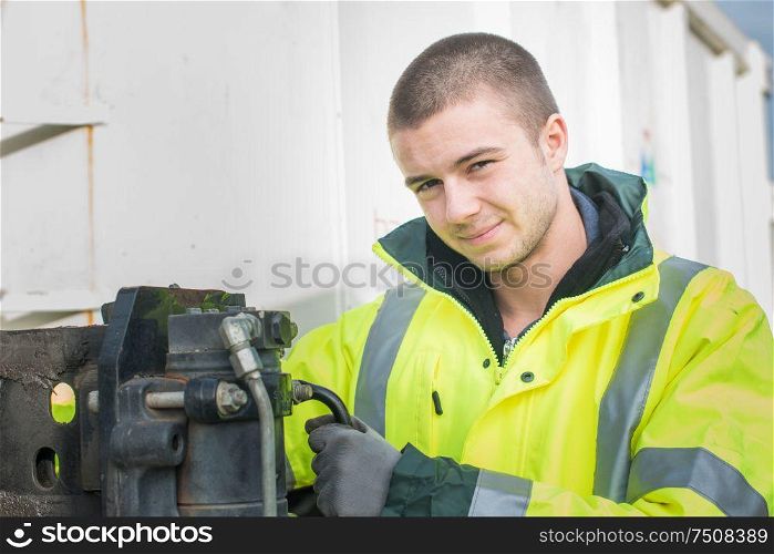 worker in warehouse looking at camera with yellow safety vest