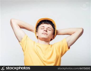 Worker in yellow helmet resting