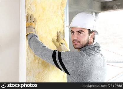 Worker installing new insulation