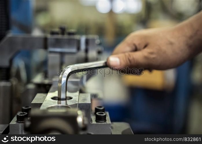 Worker is used Hexagonal screwdriver in factory