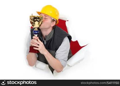 Worker kissing a trophy