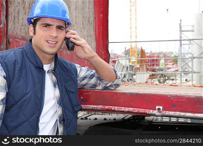 Worker leaning on red beam