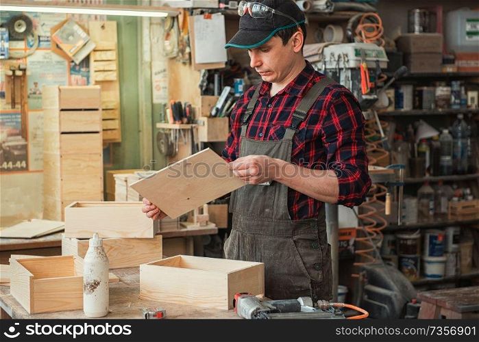 Worker making the wooden box. Profession, carpentry and woodwork concept.. Worker making the wooden box