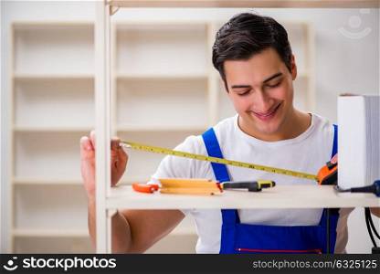 Worker man repairing assembling bookshelf