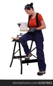 Worker measuring a tile