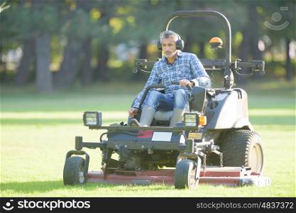 worker mowing the park