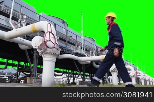 worker opens ball valve on cooling installations of gas compressor station, with alpha channel