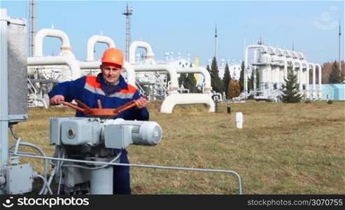 worker opens recirculation valve on compressor station of main gas pipeline