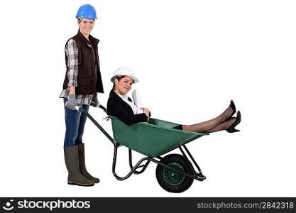 Worker pushing boss around in wheelbarrow