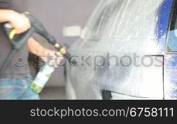 worker puts on a car wash foam