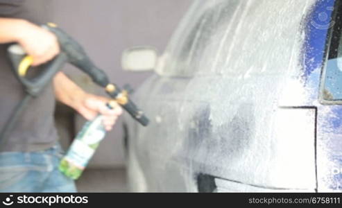 worker puts on a car wash foam