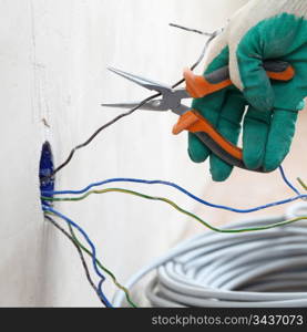 worker puts the wires in the wall