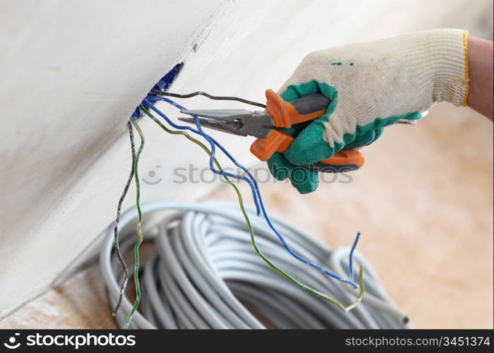 worker puts the wires in the wall